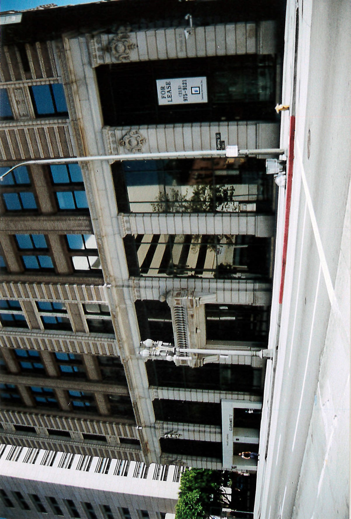 View of west facade, hotel entrance and parking garage entrance and exit